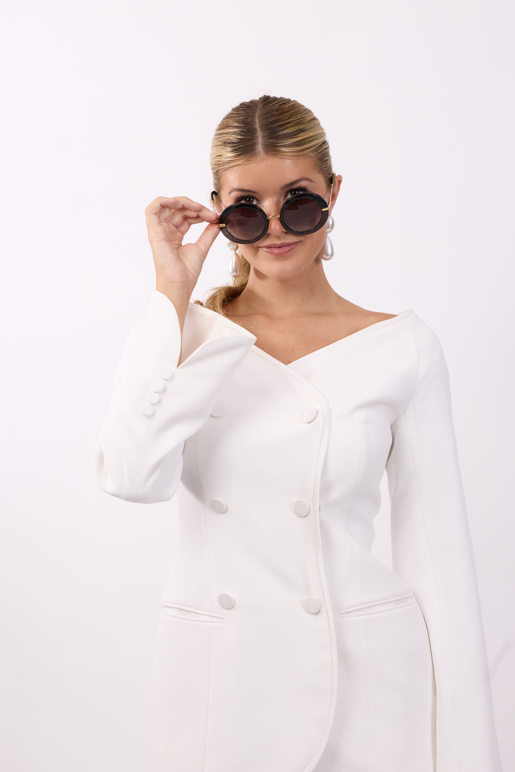 Woman wearing Nova white tailored blazer with double breasted button front design